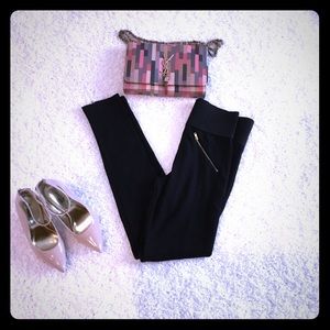 Black pants with golden  zipper at the calves